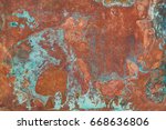 Aged copper plate texture with green patina stains. Old worn metal background.