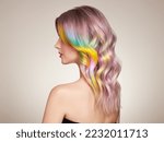 Small photo of Beauty Fashion Model Girl with Colorful Dyed Hair. Girl with perfect curly Hair. Model with perfect Healthy Dyed Hair. Rainbow Hairstyles