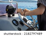 Driving motorboat on holiday. Man sailing an inflatable rubber motor boat on the sea. Boat rental close up