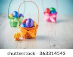 Color full easter eggs in a basket on a white table