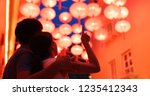 Small photo of Couple enjoy the red chinese lantern