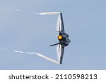 Small photo of Close view of a F-35C Lightning II in a high G maneuver, with condensation clouds over the wings and trails at the wing tips, and afterburner on