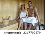 young happy couple relaxing in sauna. romantic spa getaway. copy space