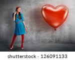 Woman holding a heart shaped balloon
