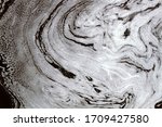 Small photo of Plume of foam floating on rapid river. Constantly changing macro pattern, stochastic process, connecting statics (microlevel) and dynamics (macrolevel). View from top. Result of water pollution
