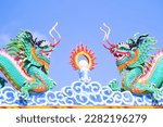 Small photo of Elements of Thai Temple sculpture: dragon, three-faced janus, samsara, solstice, elephant, symbols of power, caitya, etc. Ecclesiastical luxury. Emblem oriental dragons against the blue sky harmonize