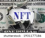 NFT ( Non-Fungible Token --  a blockchain asset) text in a torn dollar bill                               