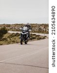 Small photo of Sierra de los Filabres, Spain - May 5th 2021: Motorbike rider riding BMW R 1250 GS motorcycle in a mountain road across beautiful turns, during Dunlop Xperience event in Sierra de los Filabres, Spain.