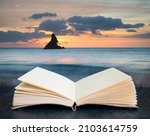 Stunning sunrise landsdcape of idyllic Broadhaven Bay beach on Pembrokeshire Coast in Wales coming out of pages on book in composite image