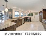 Small photo of Beautiful modernized epicurean kitchen with natural brown cabinets, granite countertops and mosaic backsplash. Northwest, USA