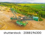 Aerial view of bucket wheel excavator, heavy equipment for surface mining. Turow coal mine, Poland, European union. Environmental problem from drone view. 