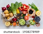 Selection of fresh raw vegetables, fruits and beans on light gray background. Organic food concept. Top view