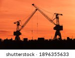 Port Cranes Silhouettes Over...