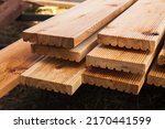 Stacked larch deck boards ...