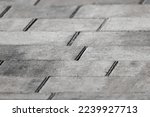 Gray concrete cobble road background, paving slabs close-up photo with selective soft focus
