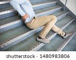 Mature Man Lying On Staircase...