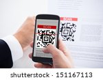 Close-up Of Businessman Scanning A Barcode Using Cell Phone