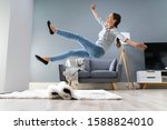 Small photo of Photo Of Woman Stumbling With A Carpet In The Living Room At Home