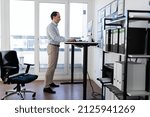 Adjustable Height Desk Stand In Office Using Computer