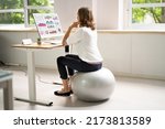 Correct Posture At Desk In Office Using Fitness Ball