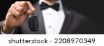 Small photo of Valet Parking Chauffeur Holding Car Key. African American Butler