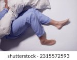 Man With RLS - Restless Legs Syndrome. Sleeping In Bed