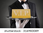 Close-up Of Waiter Showing Vip Text On Banner