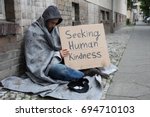 Male Beggar In Hood Showing...