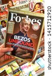 Small photo of MONTREAL, CANADA - SEPTEMBER 28, 2018: Forbes magazine with Jeff Bezos on the cover in a hand. Jeff Bezos is president of Amazon. Forbes is an American family-controlled business magazine.