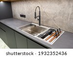 Modern interior of apartment. Luxury grey kitchen set. Huge sink. Built-in elements.