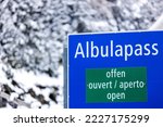 an open sign of the swiss albulapass alpine pass in the winter