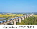 high speed trains on elevated approach bridges and rural landscape in autumn, Anhui province, China