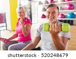 Senior couple exercising in gym 