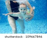 Little Boy Learning To Swim In...