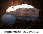 Female Rock Climber On A Cliff...