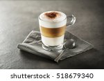 Glass of hot Latte macchiato coffee close up.