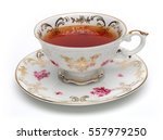 Black tea in antique tea cup isolated on white background