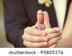 wedding rings on her fingers painted with the bride and groom, funny little men