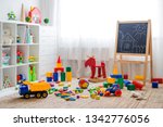 Children's playroom with plastic colorful educational blocks toys. Games floor for preschoolers kindergarten. interior children's room. Free space. background mock up chalkboard