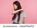 Small photo of Get out, leave me! Portrait of irritated dissatisfied brunette girl in striped t-shirt showing way out, ordering to go away, feeling betrayed and vexed. indoor studio shot isolated on pink background