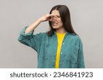 Small photo of Woman pinching nose, stop breathing bad odor, disgusted by smell of farting, her grimace expressing repulsion, gross, wearing casual style jacket. Indoor studio shot isolated on gray background.