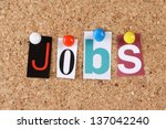 The word Jobs in cut out magazine letters pinned to a cork notice board
