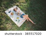 Girl in nature lying on the grass and reading book