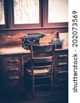 Small photo of Ghostwriter Desk. Vintage Desk with Aged Typewriter and Wooden Ghostwriter Chair.