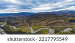 Small photo of Engineer Creek and Dempster Highway in breathtaking autumn fall wilderness landscape seen from above on Sapper Hill, Yukon Territory, YT, Canada