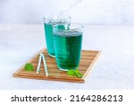 two glasses of diabolo menthe, french popular non-alcoholic mixed drink, side view