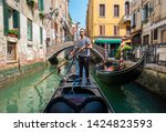 Handsome gondolier during gondola ride on the street of Venice, Italy