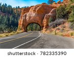 Arch tunnel through rock along scenic highway 12 near Red Canyon. Utah