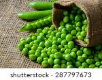 hearthy fresh green peas and pods on rustic fabric background