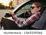 Small photo of Female car driver in sunglasses, boorish behavior